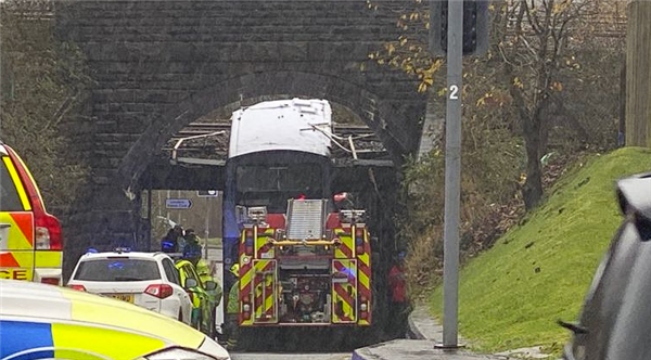 Double-decker bus sustains 'headline' damage after hitting bridge in the UK: 15 injured